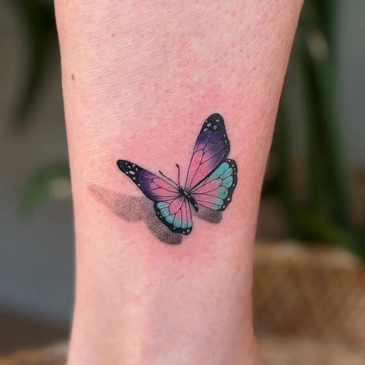 Small Watercolor Butterfly on Women Ankle Tattoo by @oslo.tattoo.ink