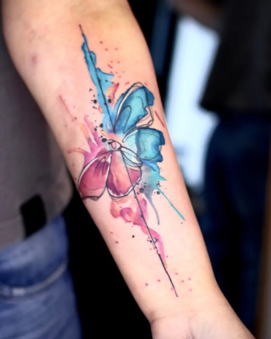 Small Watercolor Butterfly on Women Arm Tattoo by @ycoiado.ink