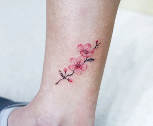 Small Watercolor Cherry Blossom Branch on Women Ankle Tattoo by @tattooer_nina