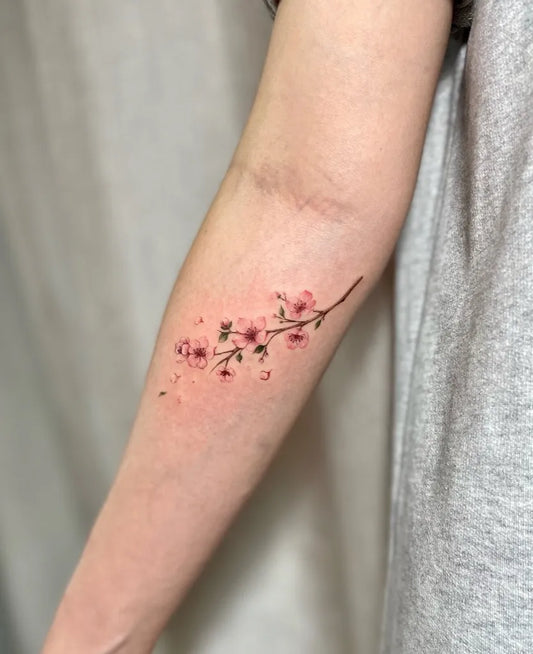Small Watercolor Cherry Blossom Branch on Women Arm Flower Tattoo by @leb_tattoo