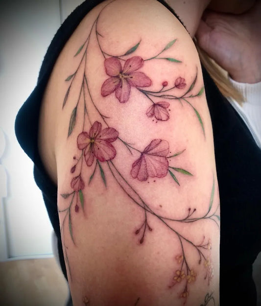Small Watercolor Cherry Blossom Branches on Women Shoulder Flower Tattoo by @nadege_quentin_tattooist