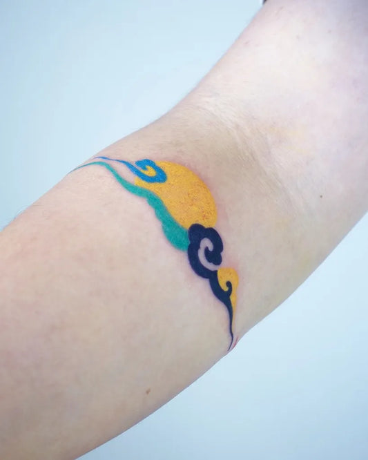 Small Watercolor Cloud and Sun Tattoo on Women Arm by @hansiitattoo
