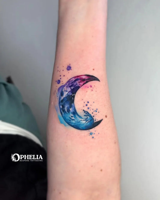 Small Watercolor Crescent Moon Tattoo on Women Forearm by @ophelia.bespoke.tattooing