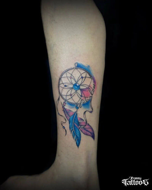 Small Watercolor Dream Catcher Feathers Tattoo on Women Ankle by @danny.tattooist