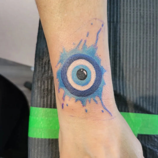 Small Watercolor Evil Eye on Women Wrist Tattoo by @kay.m13