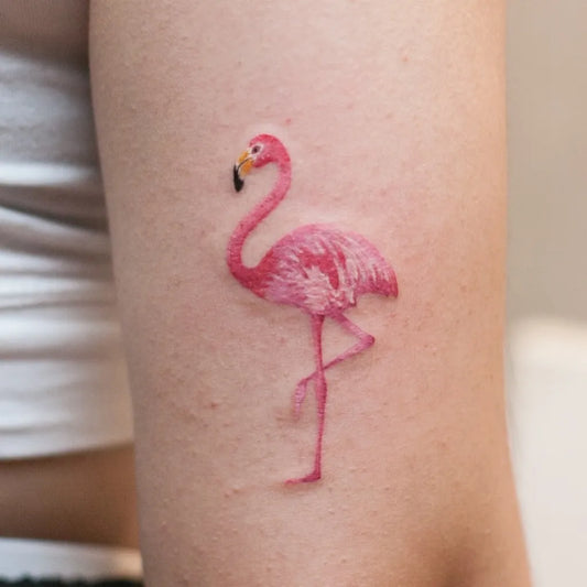 Small Watercolor Flamingo Tattoo on Women Arm by @graffittoo