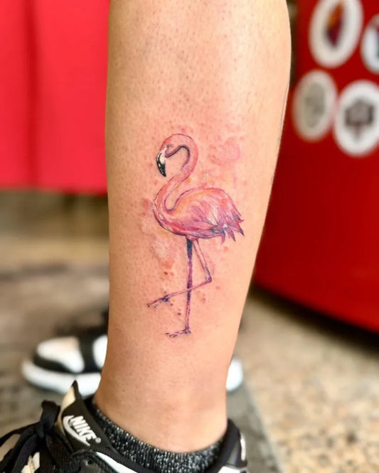 Small Watercolor Flamingo Tattoo on Women Leg by @buccaneertattoo