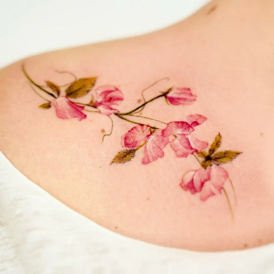 Small Watercolor Flower Vine Tattoo on Women Shoulder by @suryeon.tattoo