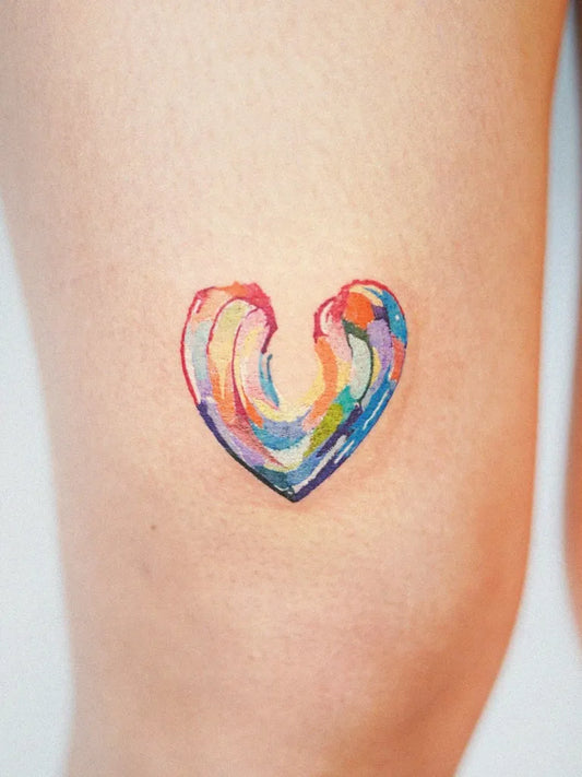 Small Watercolor Heart on Women Thigh Tattoo by @rainisline