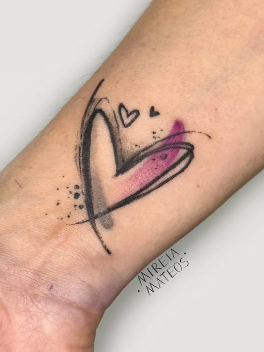 Small Watercolor Heart with Splashes on Women Wrist Tattoo by @mireiamateostattoo