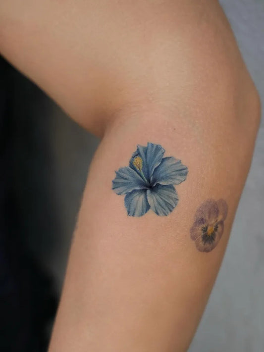 Small Watercolor Hibiscus and Pansy on Women Arm Flower Tattoo by @cigdemozsy