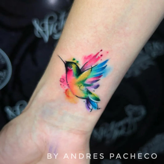 Small Watercolor Hummingbird on Women Wrist Tattoo by @victoriainktattoo