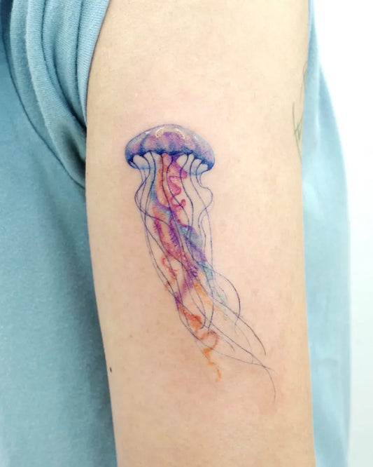 Small Watercolor Jellyfish Tattoo on Women Arm by @vismstudio