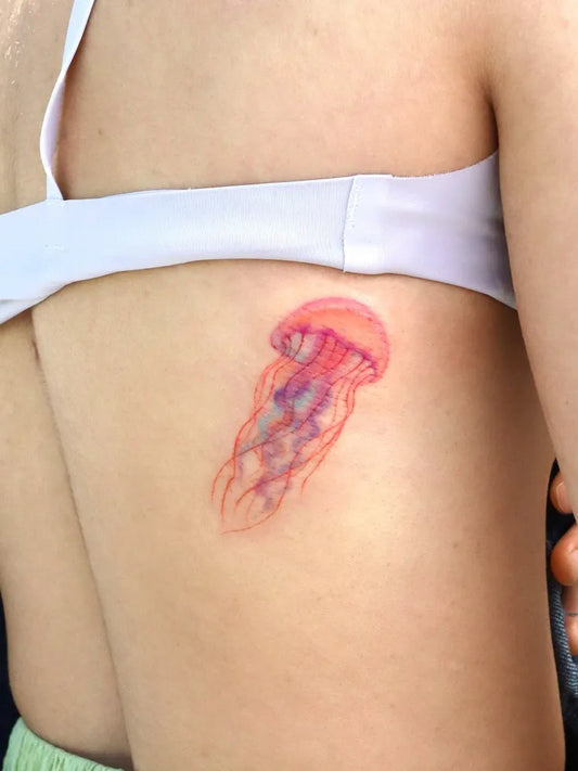 Small Watercolor Jellyfish Tattoo on Women Back by @eunyutattoo