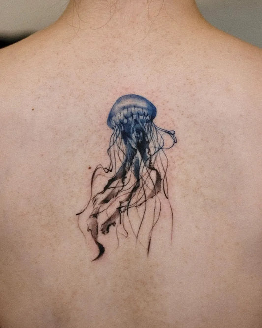 Small Watercolor Jellyfish Tattoo on Women Back by @lilt__black