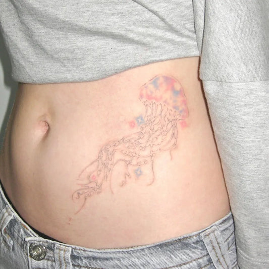 Small Watercolor Jellyfish Tattoo on Women Side by @googong.poke