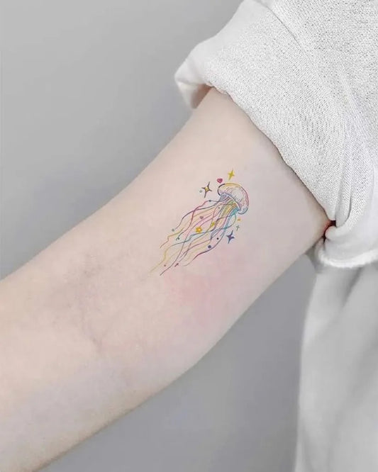 Small Watercolor Jellyfish and Stars Tattoo on Women Arm by @tattoo_korea_