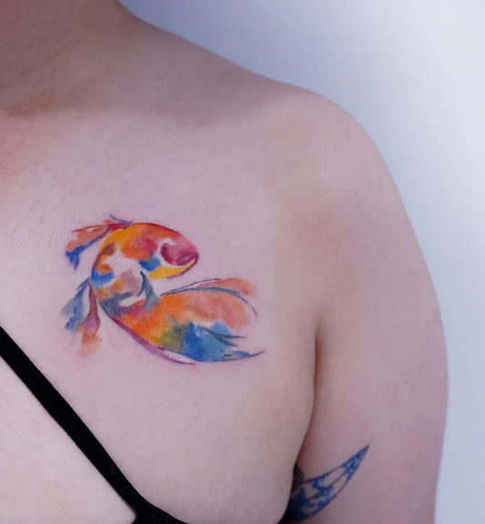 Small Watercolor Koi Fish on Women Shoulder Tattoo by @ching_artist