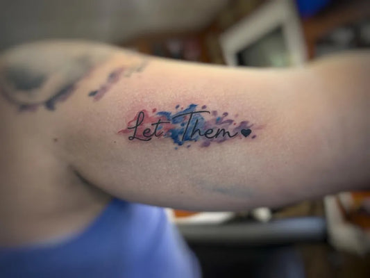 Small Watercolor Let Them Script on Women Arm Tattoo by @meridiantattoo