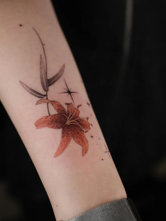 Small Watercolor Lily and Leaves on Women Arm Flower Tattoo by @hachi__bamstudio