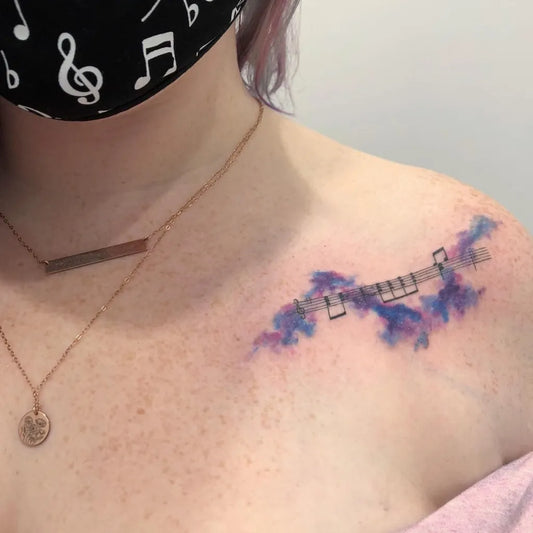 Small Watercolor Musical Notes Tattoo on Women Collarbone by @louiseflowerbloom