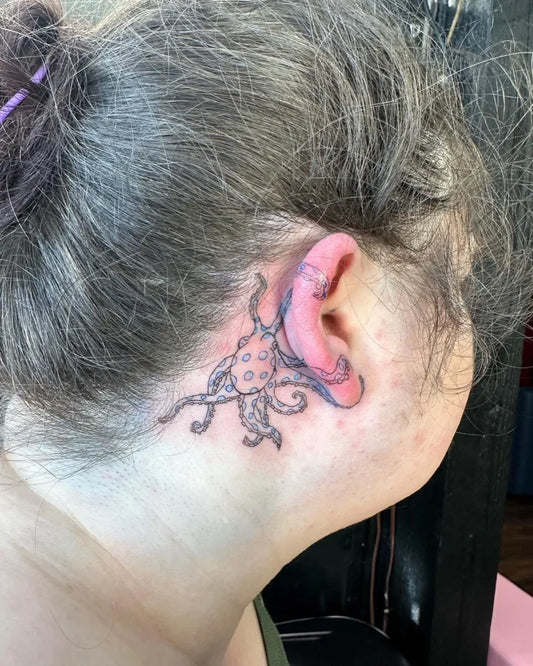 Small Watercolor Octopus Tattoo on Women Behind the Ear by @danielledtattoos