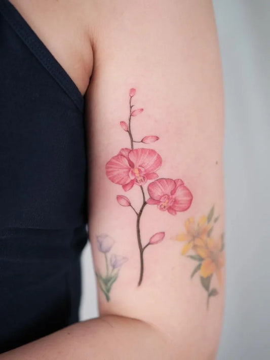 Small Watercolor Orchid Flowers Tattoo on Women Arm by @zoetattoo123