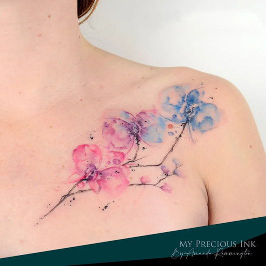 Small Watercolor Orchids on Women Shoulder Tattoo by @amanda.mypreciousink