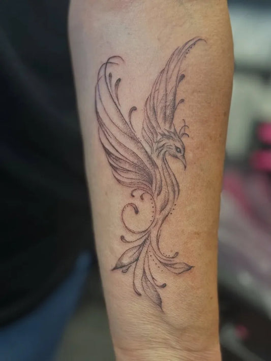Small Watercolor Phoenix on Women Arm Tattoo by @n_lines_tattoo