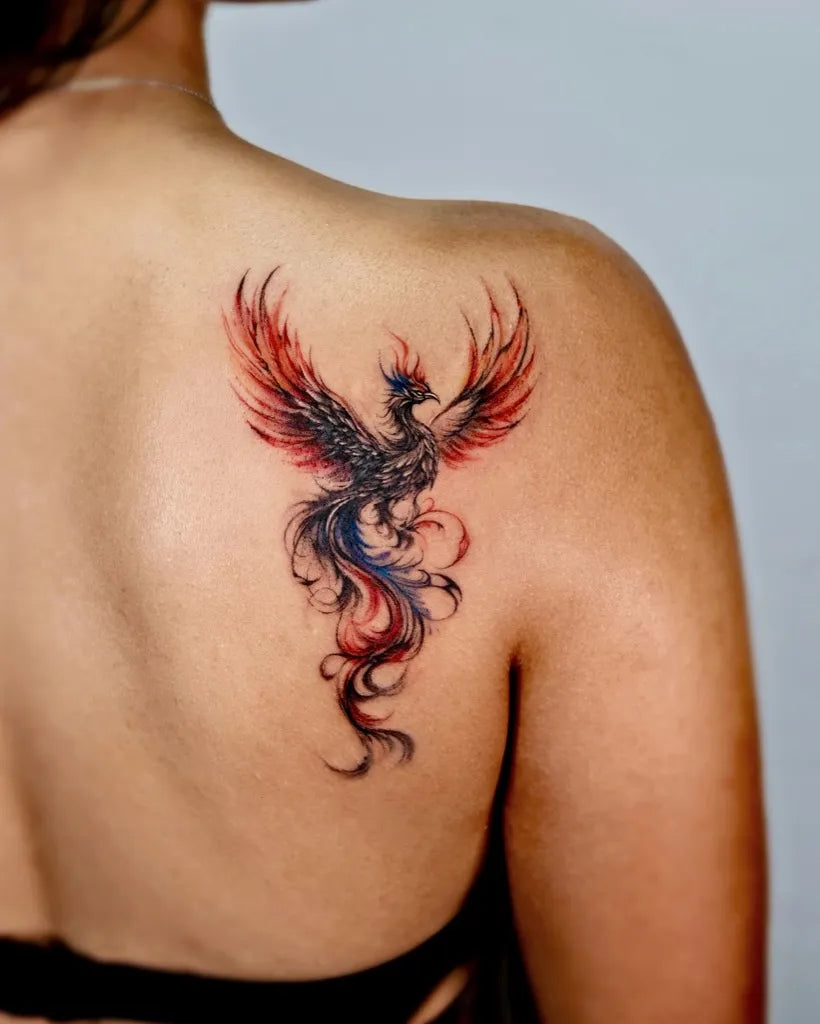 Small Watercolor Phoenix on Women Shoulder Tattoo by @sansa.jr.tattoo