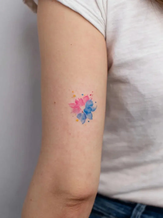 Small Watercolor Pink and Blue Flowers on Women Arm Tattoo by @finelinetattoo_korea