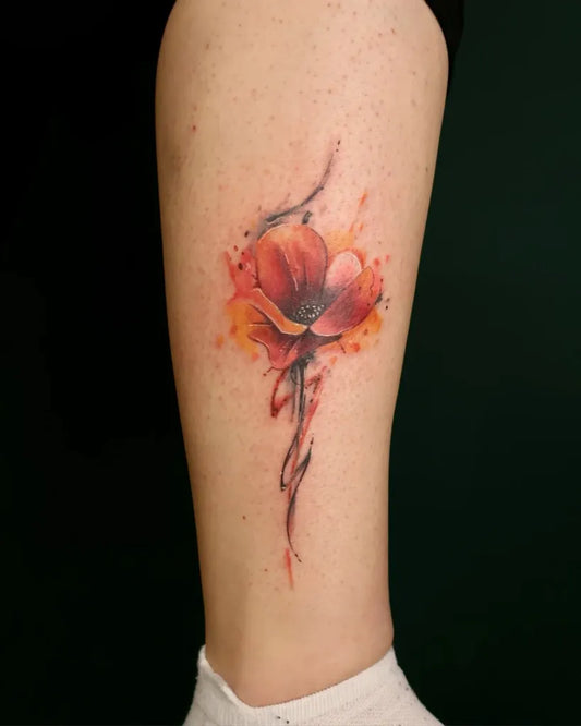 Small Watercolor Poppy Flower on Women Leg Tattoo by @silverinkzg