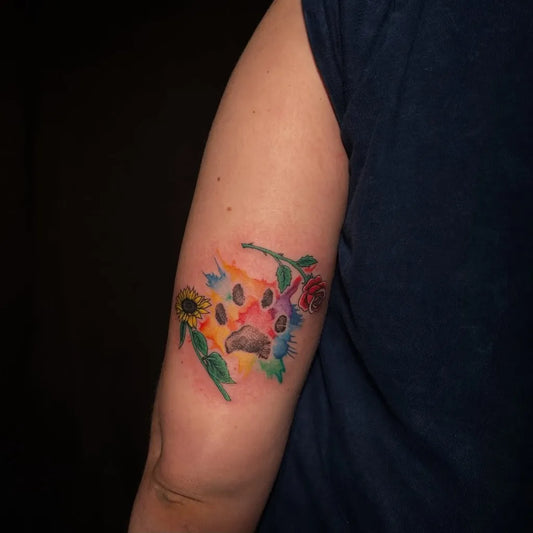 Small Watercolor Rainbow Paw Print with Sunflower and Rose on Men Arm Tattoo by @angeline.tattoo
