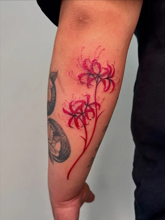 Small Watercolor Red Spider Lily Tattoo on Women Arm by @sabrinawu_tattoo
