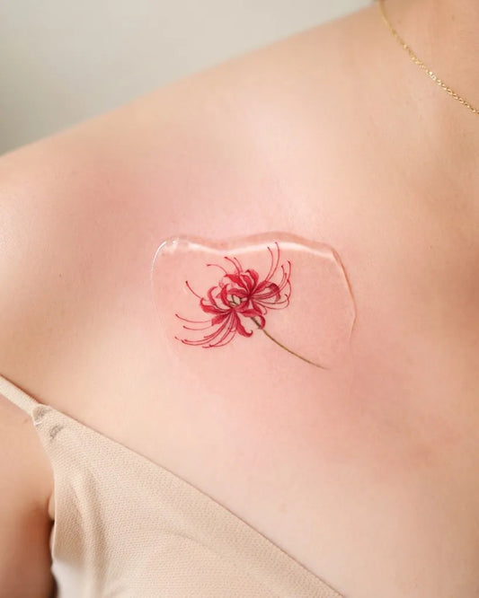 Small Watercolor Red Spider Lily Tattoo on Women Shoulder by @soap.tattoo