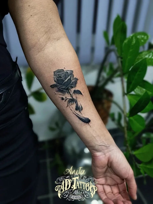 Small Watercolor Rose Feather on Women Arm Tattoo by @ad.tattoofamily13