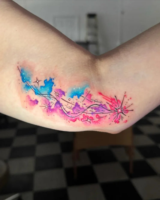 Small Watercolor Stars and Swirls on Women Arm Tattoo by @hella_vanilla