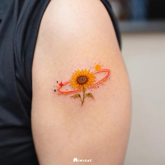 Small Watercolor Sunflower and Orbiting Sun on Women Upper Arm Tattoo by @minicat_tattoo