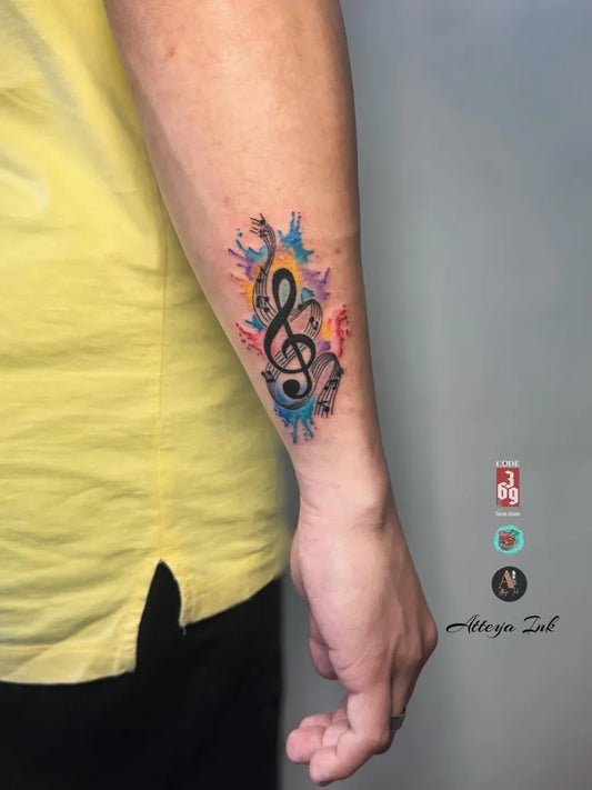 Small Watercolor Treble Clef with Butterfly Music Tattoo on Men Wrist by @atteya.ink