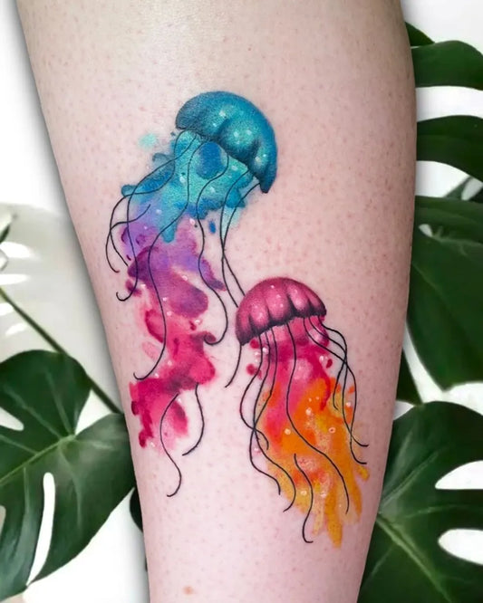 Small Watercolor Two Jellyfish on Women Thigh Tattoo by @saltyinkk