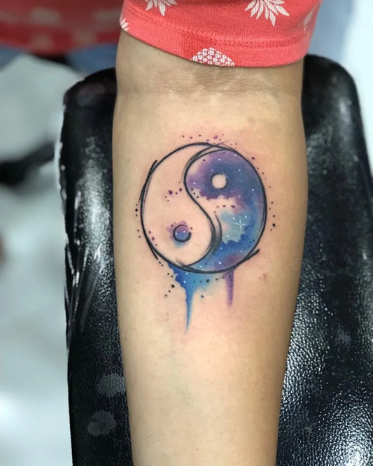 Small Watercolor Yin Yang Tattoo on Women Arm by @linesnshadestattoo_studio
