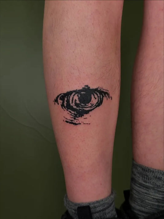 Small Woodcut Eye Tattoo on Women Leg by @tapiotats