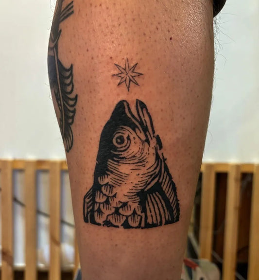 Small Woodcut Fish Star Tattoo on Men Leg by @tattedtrout