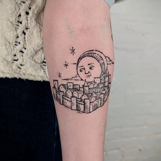 Small Woodcut Moon with Cityscape Tattoo on Women Forearm by @_art.of.gold