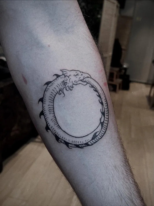 Small Woodcut Ouroboros Tattoo on Men Forearm by @raudskinna