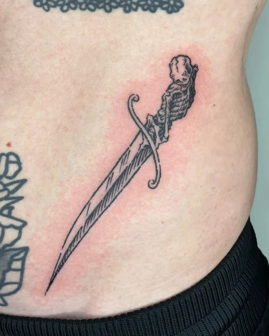 Small Woodcut Skeleton Dagger Tattoo on Men Hip by @5.5volt_tattoo