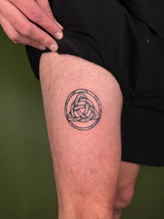 Small Woodcut Triquetra Tattoo on Men Thigh by @tapiotats