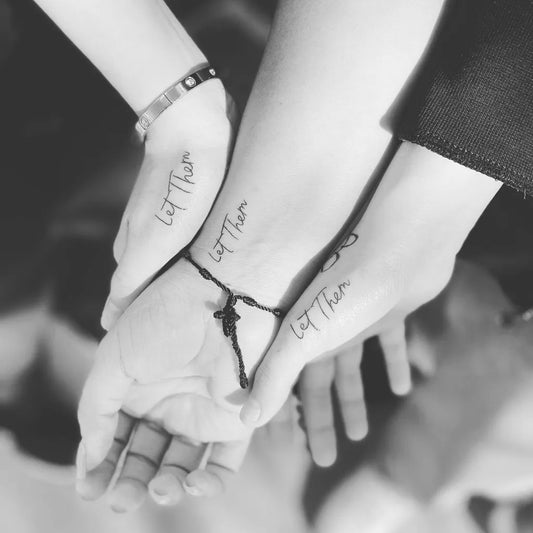 Small Word Let Them on Women Wrist Tattoo by @crimsonredtattoos