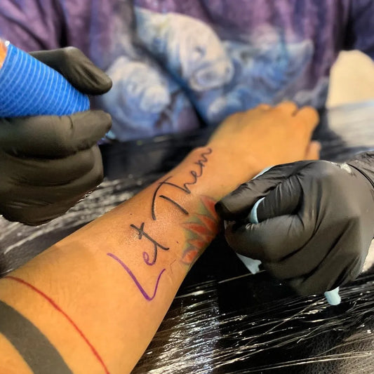 Small Word Script Let Them on Women Wrist Tattoo by @primaldovesong