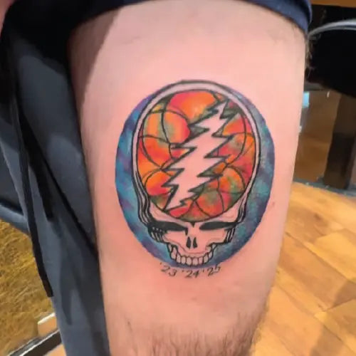 color grateful dead logo tattoo on thigh